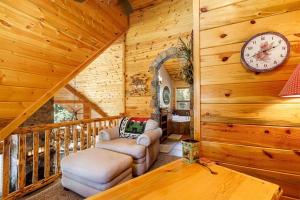 a living room with a clock on a wooden wall at Great Escape Retreat Hot Tub Fire Pit in Duck Creek Village