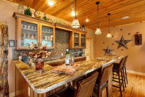 a kitchen with a large island with a counter top at Great Escape Retreat Hot Tub Fire Pit in Duck Creek Village