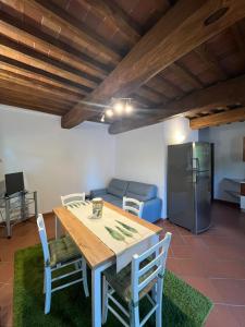 a kitchen and dining room with a table and a refrigerator at Appartamento Bellavista in Radda in Chianti