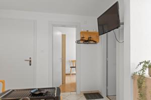 a living room with a flat screen tv on a wall at Zermatt 4 pers, 3 lits - vue & calme in Zermatt