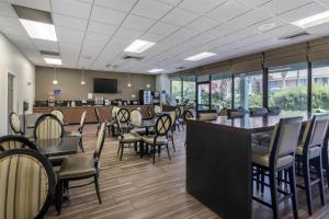 a dining room with tables and chairs and windows at Best Western Charleston Inn in Charleston