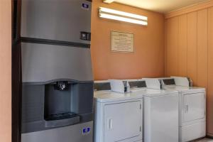 a row of washers and dryers in a room at Best Western Charleston Inn in Charleston