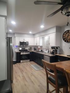 een grote keuken met witte kasten en een houten tafel bij 6 bedroom! Pool Table, Gaming Area, Firepit & More in Joliet +41 foto's