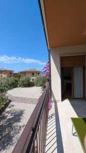 a balcony of a house with a view of the ocean at Lake Garda Renovated Apartment in Torri del Benaco +39 photos