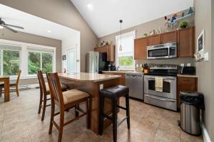 a kitchen with a table and some chairs in it at The Pronghorn - 97 Butternut in Cherry Valley