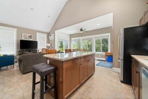 a kitchen with an island in the middle of a living room at The Pronghorn - 97 Butternut in Cherry Valley