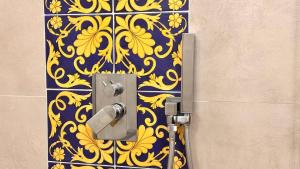 a door with a yellow and blue pattern on a wall at Hotel Villa Cedrino in Dorgali