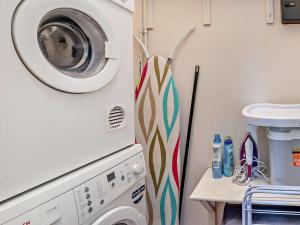a laundry room with a washer and a washing machine at 3 Bed in Brecon Town BN134 in Brecon
