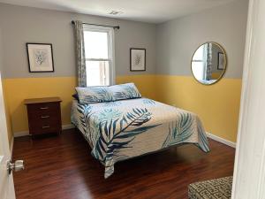 a bedroom with a bed and a mirror at JD Apartment and House in Seaside Heights