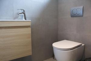 a bathroom with a toilet and a sink at Hotel Taxis Bratislava - Suites in Bratislava