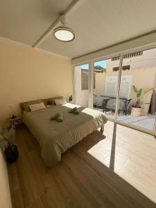 a bedroom with a large bed and a large window at La casa de Lucas in Orihuela