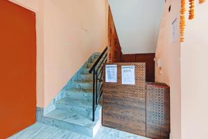 a staircase in a building with a blue stair case at Super Hotel O Shree Residency in Thākurdwari