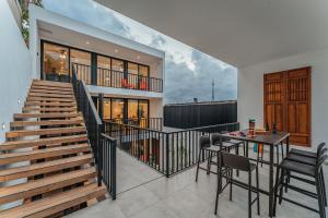 a house with a staircase and a table and chairs at La Regina de Paseo Montejo in Mérida