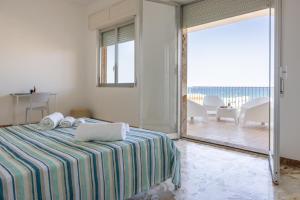 una camera con un letto e una grande porta scorrevole in vetro di Casa Liliana 1 a Cava dʼAliga