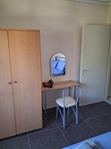 a room with a desk and a chair and a mirror at Kalyves Beach in Kalives Poligirou