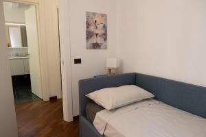 a bedroom with a blue couch with a pillow on it at Cinema Suite in Santa Margherita Ligure