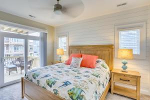 a bedroom with a bed and a balcony at Surf City Home with Outdoor Shower Walk to Beach! in Surf City
