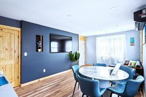a dining room with a table and blue walls at Sea & Sun Cottage #3 in Hampton