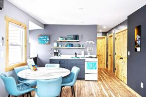 a kitchen with a table and chairs and a sink at Sea & Sun Cottage #3 in Hampton
