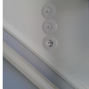 a white ceiling with a bunch of buttons on it at Stonebuilt boutique apartment Levanda in Kymi