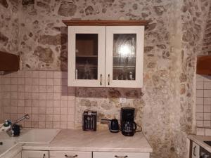a kitchen with a counter and a sink and a window at Rethymno Rustic Serenity in Rethymno Town