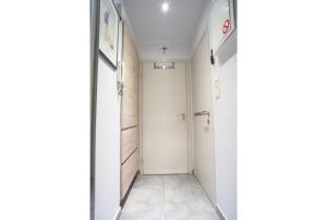a corridor with a white door in a room at Studiodevos in Middelkerke