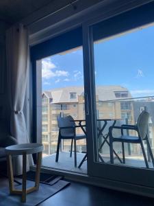 a view of a balcony with a table and chairs at Studiodevos in Middelkerke