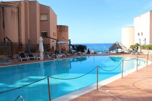 a large swimming pool next to a building at Mondello Addaura Home Holiday in Mondello