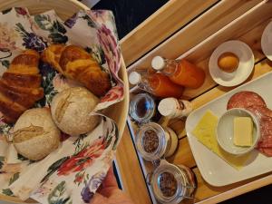 a tray of food with bread and eggs on it at Cosy private cottage with stunning view in Sunne +8 photos