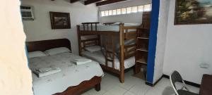 a room with a bed and a bunk bed and a room with a bunk bed at Hospedaje Turistico Angula Place in San Andrés +56 photos