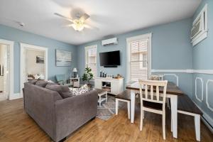 a living room with a couch and a table at The Catbird - 28 Butternut in Cherry Valley