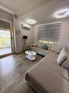 a living room with a couch and a table at Coco Apartments in Vlorë +4 photos