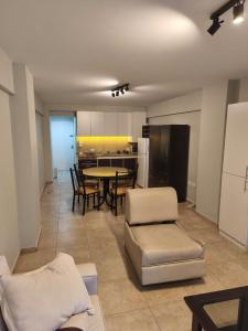 a living room with a table and chairs and a kitchen at Rodalquilar in Mar del Plata +8 photos