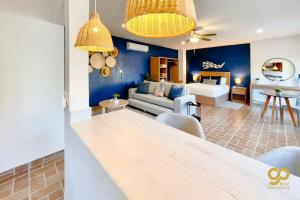 a living room with a couch and a table at Chic Studio Kitchen WiFi TV Steps to Beach in El Centenario