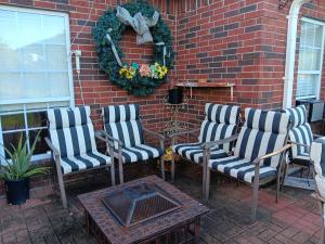 a group of chairs sitting next to a brick wall at Klauzz in Bay City