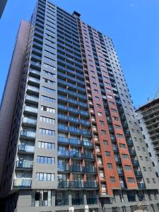 a tall apartment building with many windows at Apartment, premium class, near the sea 1718 batumi in Batumi