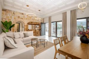 a living room with a white couch and a table at Anar Luxury Villas in Kalamaki
