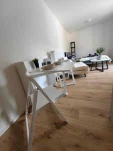 a white table and chairs in a living room at Apartman Anjel Teplice in Trenčín +9 photos