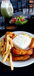 a plate of food with a sandwich and french fries at Casa de Campo in Santo André +19 photos