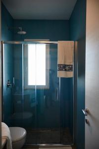 a bathroom with a shower with a glass door at VILLA BY THE SEA - Accesso Privato al Mare in Polignano a Mare