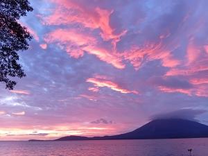 a sunset over a body of water with a cloudy sky at Cabaña el ojoche in Balgue