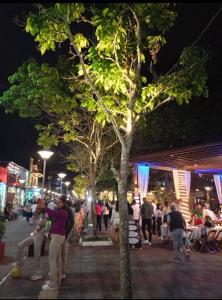 a crowd of people standing around a street at night at Itaúna in Guaramiranga