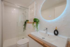 a bathroom with a sink and a toilet and a mirror at Le Chativesle - Centre - Erlon in Reims +14 photos