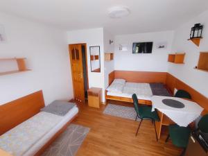 a room with two beds and a table and chairs at Willa Barbara in Tupadła