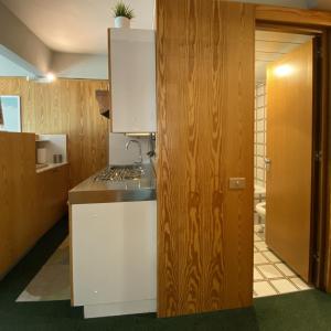 a kitchen with white cabinets and a counter top at Marilleva1400 Direct Access to Skii Slopes in Mezzana