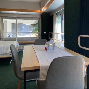 a hospital room with a table and chairs and a bed at Marilleva1400 Direct Access to Skii Slopes in Mezzana