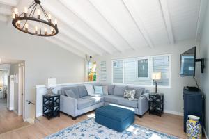 a living room with a blue couch and a chandelier at 304 Ruby Ave B in Newport Beach