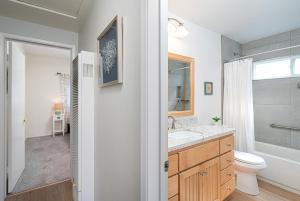 a bathroom with a sink and a toilet and a shower at 304 Ruby Ave B in Newport Beach