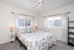 a bedroom with a bed and two windows at 304 Ruby Ave B in Newport Beach