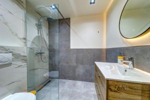 a bathroom with a shower and a sink and a mirror at При Баръма in Vishnevo +45 photos